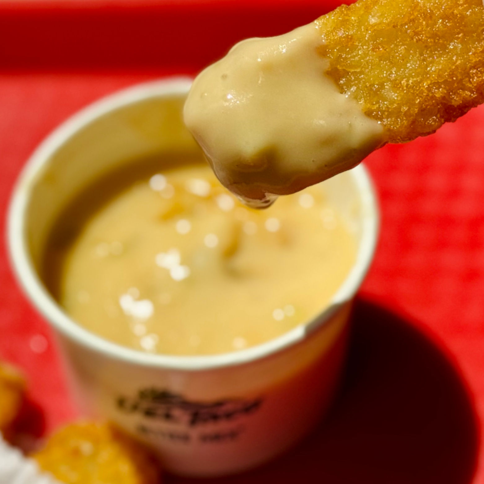 Dip Hashbrown in Queso Del Taco Queso Hashbrown